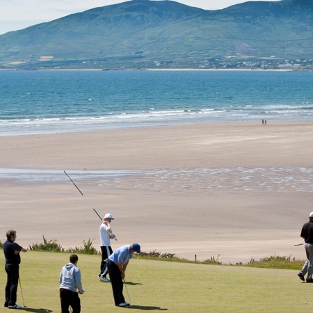 Golfers playing at the scenic Waterville Golf Links, with breathtaking views of the Atlantic Ocean and surrounding mountains in County Kerry, Ireland